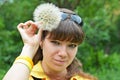 Young woman with large dandelion Royalty Free Stock Photo