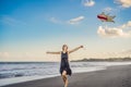 A young woman launches a kite on the beach. Dream, aspirations, future plans Royalty Free Stock Photo