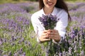 Young woman with lavender bouquet in field on summer day Royalty Free Stock Photo