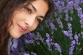 Young woman is in the lavender field, beautiful portrait, face closeup, summer landscape with red poppy flowers Royalty Free Stock Photo