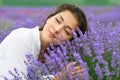 Young woman is in the lavender field, beautiful portrait, face closeup, summer landscape with red poppy flowers Royalty Free Stock Photo