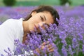 Young woman is in the lavender field, beautiful portrait, face closeup, summer landscape with red poppy flowers Royalty Free Stock Photo