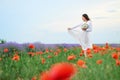 Young woman is in the lavender field, beautiful summer landscape with red poppy flowers Royalty Free Stock Photo