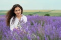 Young woman is in the lavender field, beautiful summer landscape with red poppy flowers Royalty Free Stock Photo