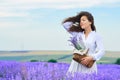 Young woman is in the lavender flower field, beautiful summer landscape Royalty Free Stock Photo