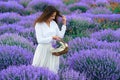 Young woman is in the lavender flower field, beautiful summer landscape Royalty Free Stock Photo