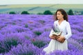 Young woman is in the lavender flower field, beautiful summer landscape Royalty Free Stock Photo