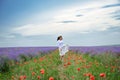 Young woman is in the lavender flower field, beautiful summer landscape Royalty Free Stock Photo