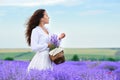 Young woman is in the lavender flower field, beautiful summer landscape Royalty Free Stock Photo
