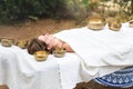 Young woman laying on a massage bed with tibetan singing bowl outdoor. Nepal copper singing bowl sound massage