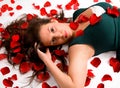 Young Woman Laying in Rose Petals Royalty Free Stock Photo