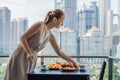 Young woman is laying on a table. Breakfast table with coffee fruit and bread croisant on a balcony against the backdrop Royalty Free Stock Photo