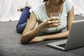 Young woman laying while using laptop Royalty Free Stock Photo