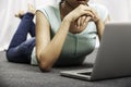 Young woman laying while using laptop Royalty Free Stock Photo