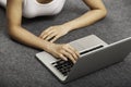 Young woman laying while using laptop Royalty Free Stock Photo