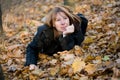 The young woman lays in autumn wood