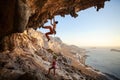 Young woman lead climbing in cave