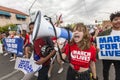 Young woman leading crowd with megaphone at gun violence protest