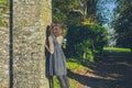 Young woman leaning against stone wall Royalty Free Stock Photo