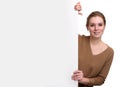 Young woman leaning on big blank board Royalty Free Stock Photo