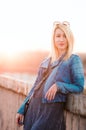 Young woman leaning on bridge fence portrait