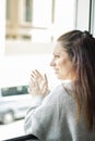 Young woman leaning out the window applauding