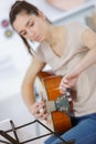 Young woman learning guitar