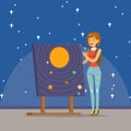 Young woman learning about the solar system at the planetarium Royalty Free Stock Photo
