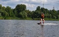 A young woman is learning to ride a wakeboard Royalty Free Stock Photo