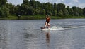 A young woman is learning to ride a wakeboard Royalty Free Stock Photo