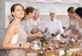 Young woman learns to cook at master class