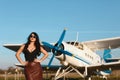 Young woman in leather skirts and glasses near the ancient airplane. Fashion Lifestyle, Portrait Royalty Free Stock Photo