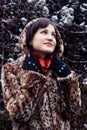 Young woman in leopard fur coat looking up Royalty Free Stock Photo