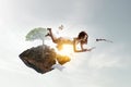 Young woman levitates while reading a book Royalty Free Stock Photo