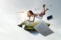 Young woman levitates while reading a book Royalty Free Stock Photo