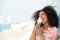 Young woman licking ice cream