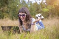 Young woman lies on the grass with a laptop and speaks emotionally on the phone. Royalty Free Stock Photo