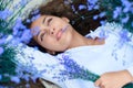 Young woman lies in the lavender flower field, beautiful summer landscape Royalty Free Stock Photo