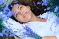 Young woman lies in the lavender flower field, beautiful summer landscape Royalty Free Stock Photo