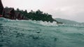 Young woman in a lifevest is jumping into water during rain