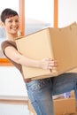 Young woman lifting cardboard box