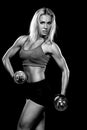 Woman lifting dumbbells black and white photo