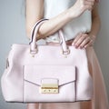 Young woman with light pink handbag, romantic casual style Royalty Free Stock Photo