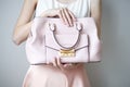 Young woman with light pink handbag, romantic casual style Royalty Free Stock Photo