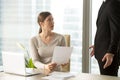 Young woman listening claims on her work from boss Royalty Free Stock Photo