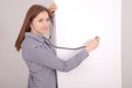 Young woman listening closed fridge with stethoscope Royalty Free Stock Photo