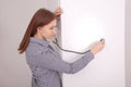 Young woman listening closed fridge with stethoscope Royalty Free Stock Photo