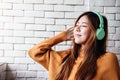 Young Woman Listening Music From Headphone in Cozy House, Closed Royalty Free Stock Photo