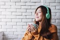 Young Woman Listening Music From Headphone in Cozy House, Closed Eyes and Relaxing Royalty Free Stock Photo