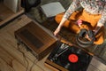 Young Woman listening a music on a HiFi system with turntable, amplifier, headphones and lp vinyl records in a listening room Royalty Free Stock Photo